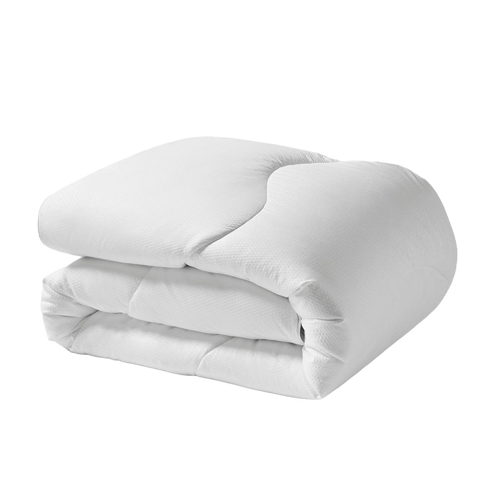 Folded white comforter on a white background